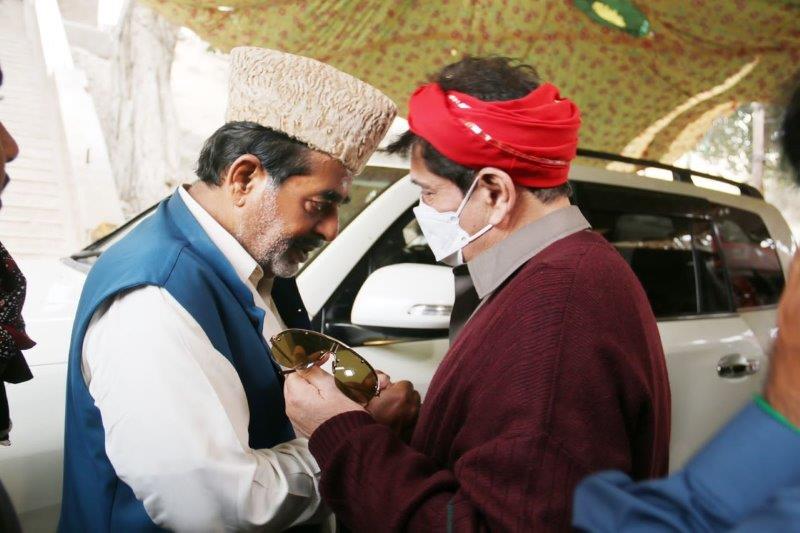 Syed Zammurud Hussein receiving Makhdoom Syed Faisal Saleh Hayat